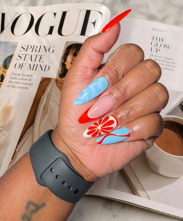 Blue and red-orange stiletto nails with citrus slice nail art