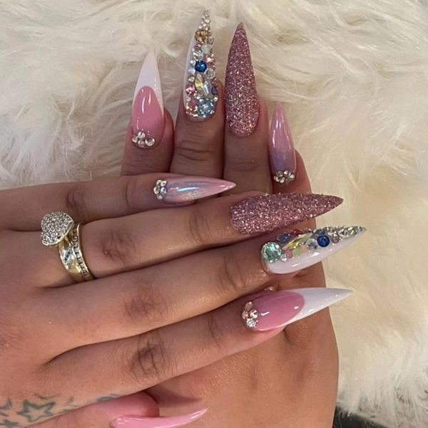 Pink stiletto acrylics with clustered rhinestones and glitter