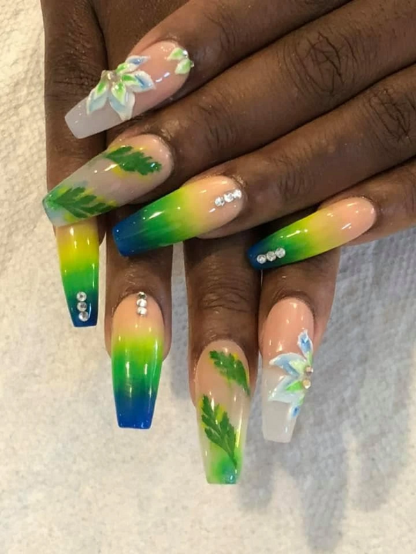 Tropical green-and-blue ombré nails with hand-painted palm leaves