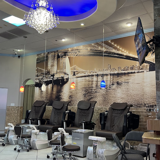 Pedicure lounge at Pink & White Nails with crystal chandelier and skyline mural